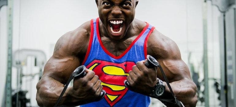 a man in a Superman shirt at the gym